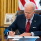 Biden at desk signing