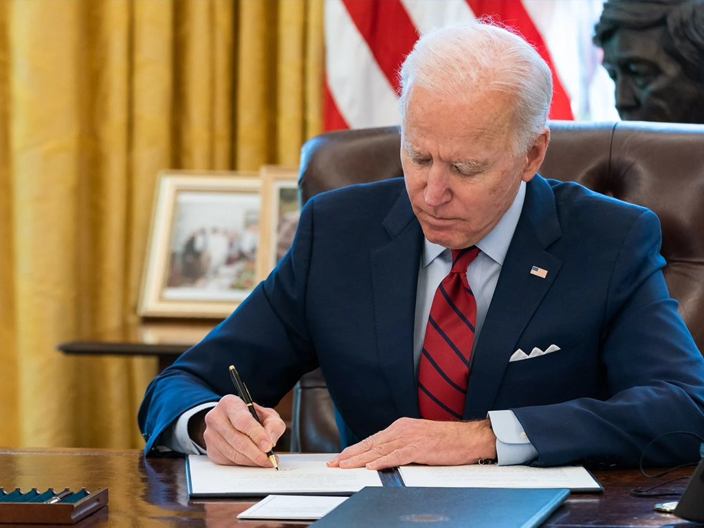 Biden at desk signing